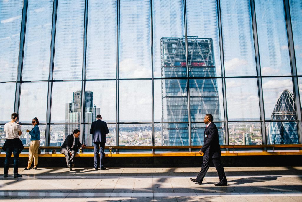 pexels photo 34092 Business professionals in a modern office against a London skyline view.